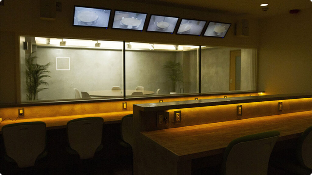 Viewing room behind the one-way mirror, with five monitors